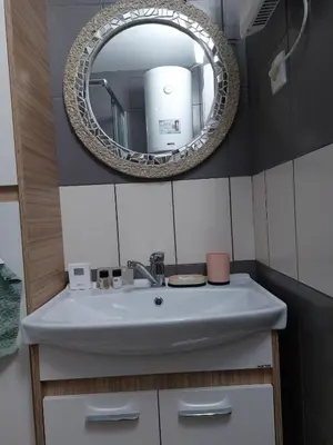 a bathroom with a white sink and a mirror at Apartman Ivana Kopaonik in Kopaonik