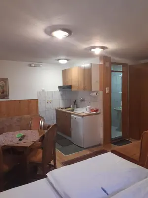 a kitchen and dining room with a table and chairs at Vila Paraglajder in Kopaonik