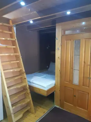 a room with a bunk bed and a ladder at Vila Paraglajder in Kopaonik