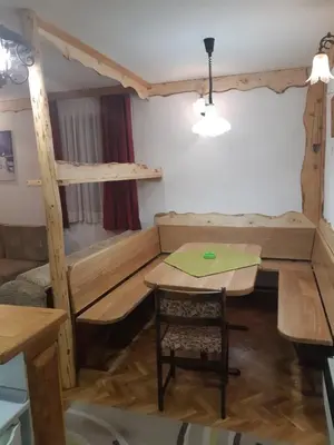 a living room with a bunk bed and a table at Vila Paraglajder in Kopaonik
