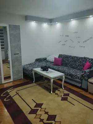 a living room with a couch and a table at Apartman Suva reka in Leskovac
