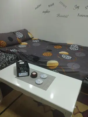 a bed with a table in a room at Apartman Suva reka in Leskovac