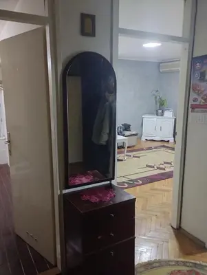a mirror on top of a dresser in a room at Apartman Suva reka in Leskovac