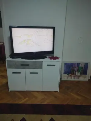 a flat screen tv sitting on a white entertainment center at Apartman Suva reka in Leskovac