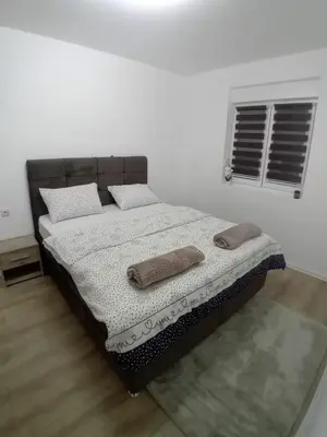 a bedroom with a bed with two pillows on it at Stan na dan Bor in Bor