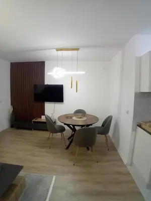 a dining room with a table and chairs at Stan na dan Bor in Bor