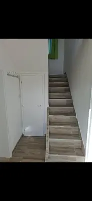 a staircase in a room with a door and a stair case at Bazen Jelasnica 1 in Niš