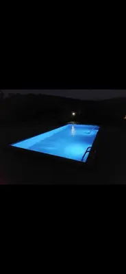 a blue pool of water in a dark room at Bazen Jelasnica 1 in Niš
