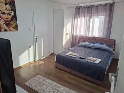 a bedroom with a bed with two towels on it at Bazen Jelasnica 1 in Niš