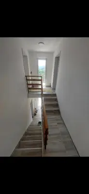 a staircase in a building with a cat laying on the floor at Bazen Jelasnica 1 in Niš