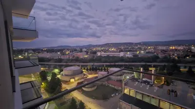 a view of a city at night from a building at Delta residence in Niš