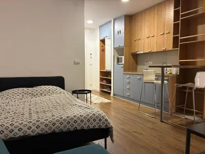a small bedroom with a bed and a kitchen at Delta residence in Niš