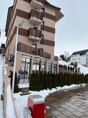 a building with a red mail box in the snow at Apartment in Belvedere Hills Luxury Apartments and Spa in Kopaonik