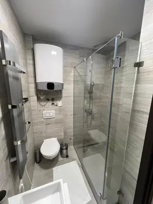 a bathroom with a glass shower and a toilet at Apartment in Belvedere Hills Luxury Apartments and Spa in Kopaonik