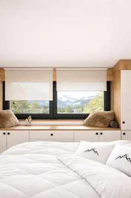 a bedroom with a white bed and a window at Apartman Monte - Ressidence Hill, Kopaonik in Kopaonik