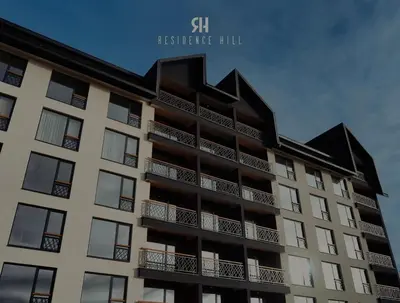 an apartment building with a black roof at Apartman Monte - Ressidence Hill, Kopaonik in Kopaonik