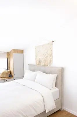 a bedroom with a large bed with white sheets at Apartman Monte - Ressidence Hill, Kopaonik in Kopaonik
