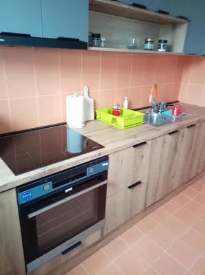 a kitchen with a sink and a stove top oven at LIN Apartman in Vladičin Han