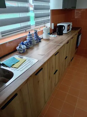 a kitchen counter with blue and white dishes on it at LIN Apartman in Vladičin Han