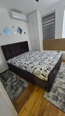 a bedroom with a large bed in a room at Apartman IVA LUX Vrnjacka Banja in Vrnjci