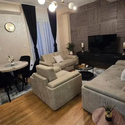 a living room with two couches and a table at Apartman IVA LUX Vrnjacka Banja in Vrnjci