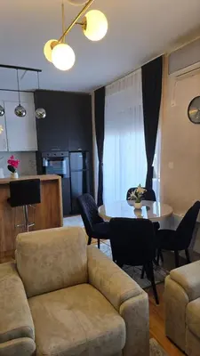 a living room with a couch and a table at Apartman IVA LUX Vrnjacka Banja in Vrnjci