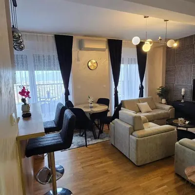 a living room with a couch and a table at Apartman IVA LUX Vrnjacka Banja in Vrnjci