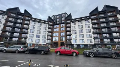 a group of buildings with cars parked in a parking lot at Sierra Apartments Residence Hill & SPA Centar in Kopaonik