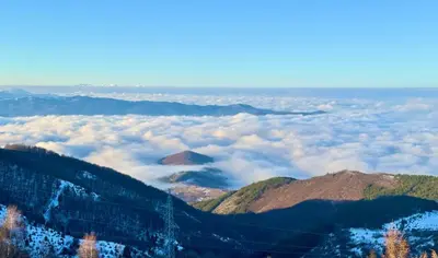 a view from the top of a mountain with clouds at Sierra Apartments Residence Hill & SPA Centar in Kopaonik
