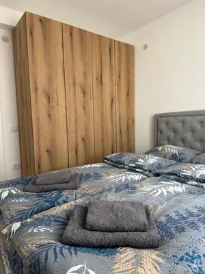 a bed with two towels on top of it at Apartman Pogled Contra in Kopaonik