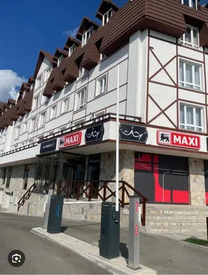 a large building with a brown and white at Kraljevi Čardaci - Despot Apartman in Kopaonik