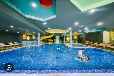 a group of people in a large swimming pool at Kraljevi Čardaci - Despot Apartman in Kopaonik