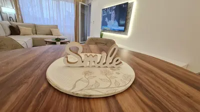 a wooden sign sitting on a table in a living room at Luxury Apartment Paraćin - City Center in Paraćin