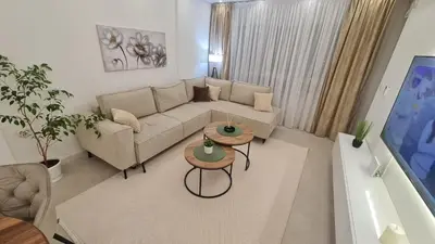 a living room with a couch and a table at Luxury Apartment Paraćin - City Center in Paraćin