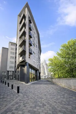 a tall building on a street with a brick road at Luxury Apartment Paraćin - City Center in Paraćin