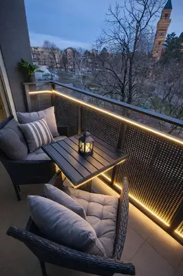 a balcony with a table and chairs and lights at Luxury Apartment Paraćin - City Center in Paraćin