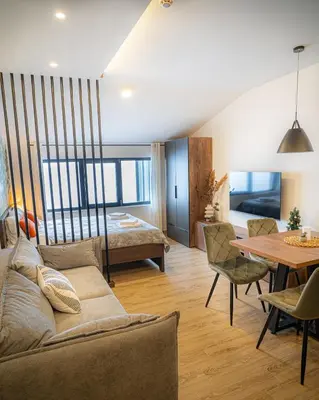 a living room with a couch and a table at Hill View B121, Kopaonik in Kopaonik