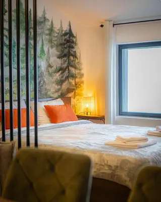 a bedroom with a bed with a painting on the wall at Hill View B121, Kopaonik in Kopaonik