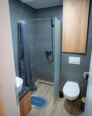 a bathroom with a shower with a toilet and a sink at Hill View B121, Kopaonik in Kopaonik