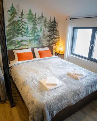 a bedroom with a bed with two towels on it at Hill View B121, Kopaonik in Kopaonik