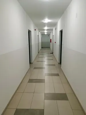 an empty hallway with white walls and tile floors at Apartman Vuk in Ćuprija