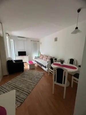 a living room with a table and a couch at Apartmani Vrnjacka Banja 7 in Vrnjačka Banja