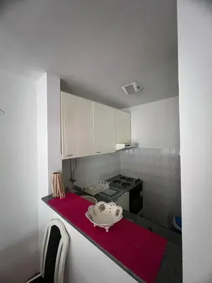 a kitchen with a bowl on a red counter at Apartmani Vrnjacka Banja 7 in Vrnjačka Banja
