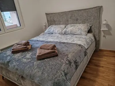a bedroom with a bed with two towels on it at Slatinski mir in Vrnjačka Banja