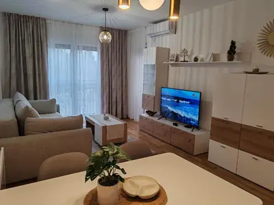 a living room with a couch and a tv at Slatinski mir in Vrnjačka Banja