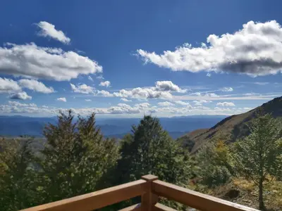a view of the mountains from a wooden railing at Nebeska Treska in Kopaonik