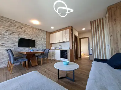 a living room with a couch and a table at Nebeska Treska in Kopaonik