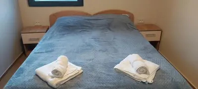 a bedroom with a bed with two towels on it at Nebeska Treska in Kopaonik