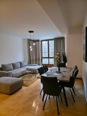 a living room with a couch and a table and chairs at Apartmani Central 2 & Free Parking in Vrnjačka Banja