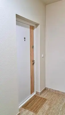 an empty room with a door and a wooden floor at Upendo Apartment in Vrnjačka Banja